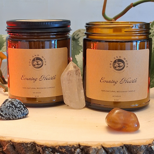 Evening Hearth 8 oz beeswax candle in amber glass jar with metal lid, natural wood wick, smoky wood, amber, and spice fragrance for cozy evenings