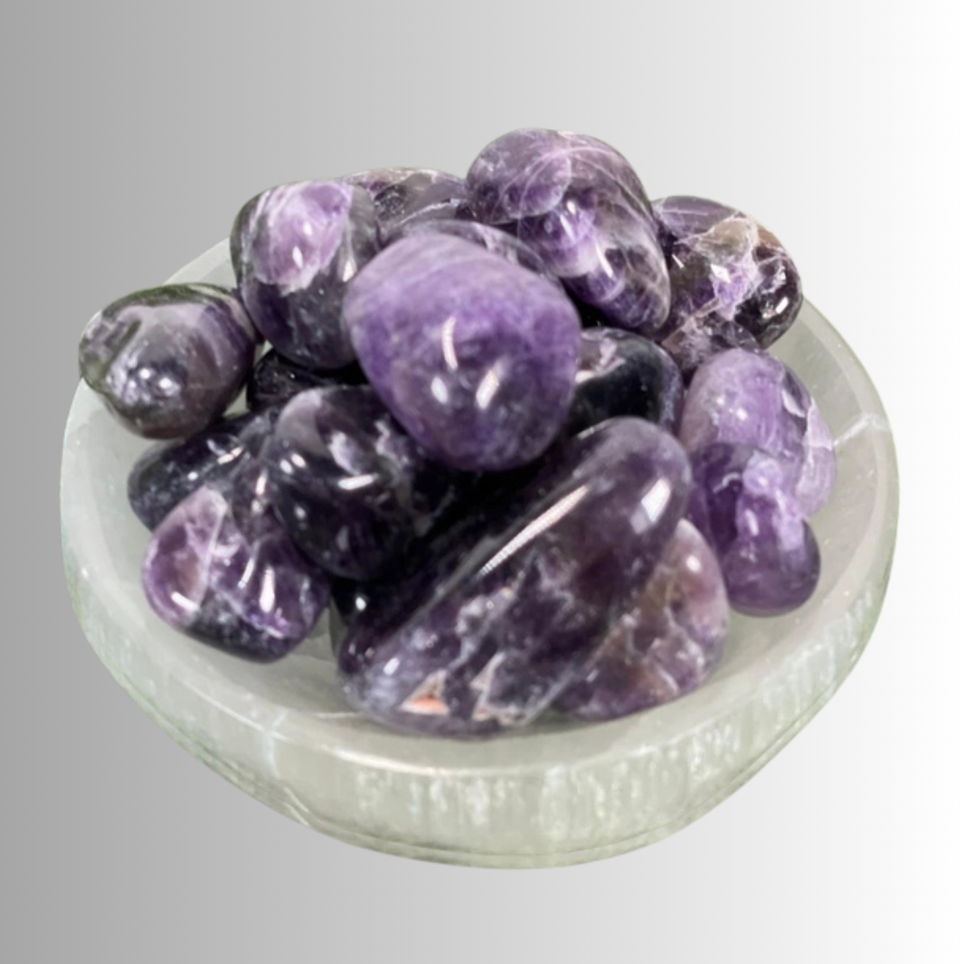 Tumbled Amethyst crystal in lavender to deep violet hues with natural banding, used for protection, intuition, and spiritual growth