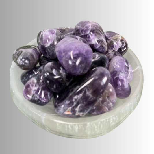 Tumbled Amethyst crystal in lavender to deep violet hues with natural banding, used for protection, intuition, and spiritual growth