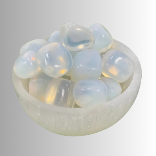 Tumbled Opalite crystal with milky glow and subtle blue-golden flashes, used for peace, communication, intuition, and spiritual connection.